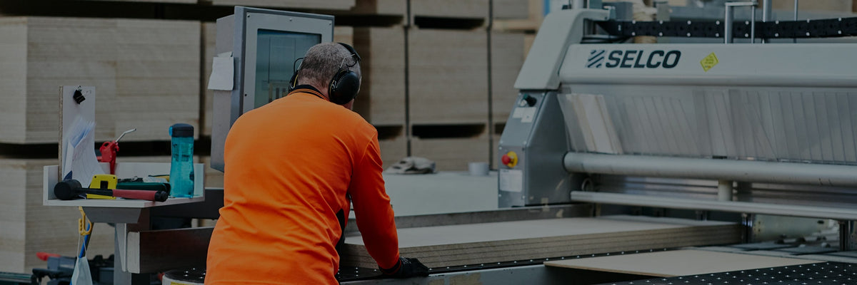 Desktop header image of a beam saw operator cutting plywood to size in Plyco Mornington
