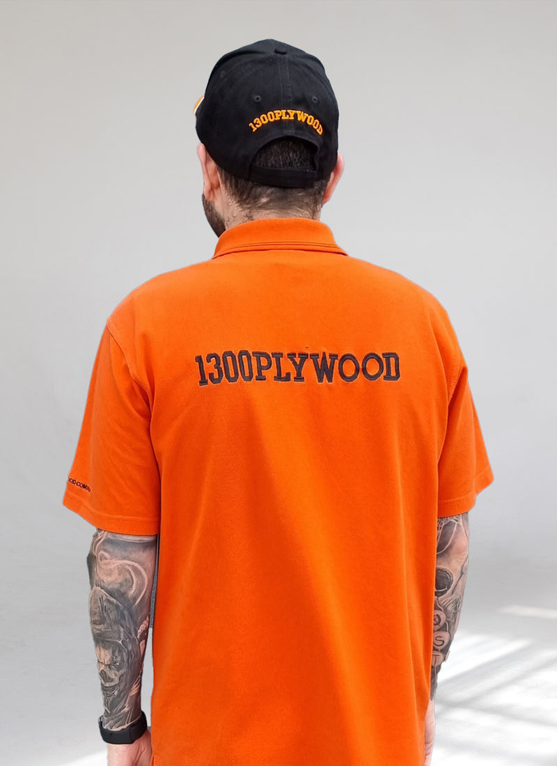 Reverse photo of Justin wearing Plyco's vintage black white and orange hat without a white background