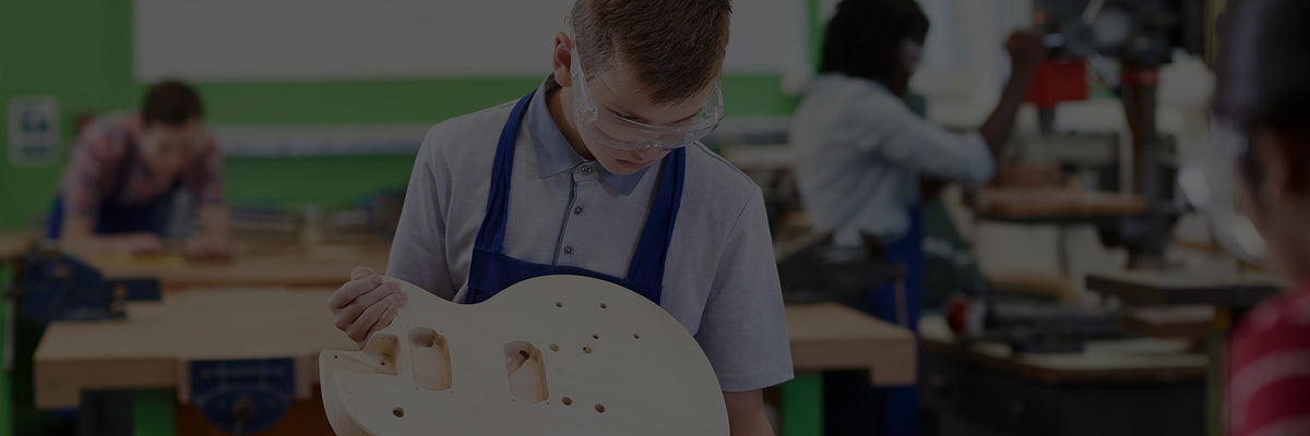 Student crafts a handmade guitar with Plyco's Poplar Laserply panels available to purchase online for educational providers