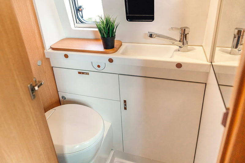 Bathroom inside a mobile home featuring doors using Plyco's Vanply plywood caravan panels
