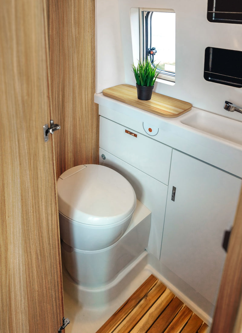 Bathroom in a RV / Caravan featuring 3mm Cervantes Oak Vanply for interior caravan wall panels and cabinets from Melbourne plywood supplier Plyco without a white background
