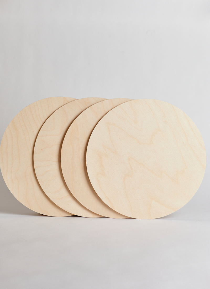 Four 3mm Birch Laserply Circles in Plyco's Craft Packs on a white background