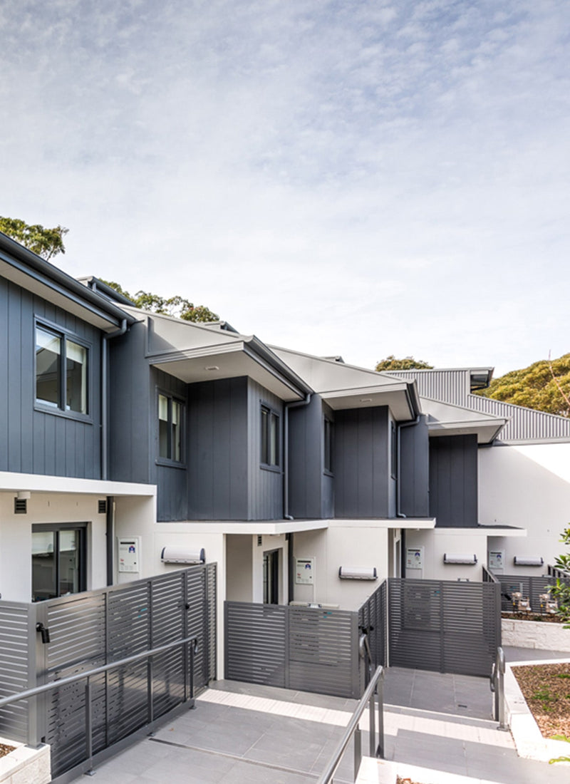 Row of townhouses built with local plywood supplier Plyco's Smooth 300 Weathergroove interior and exterior wall cladding without a white background available to buy online