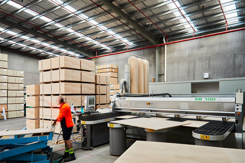 Beam saw operator offloading cut to size plywood panels in Plyco's Mornington warehouse