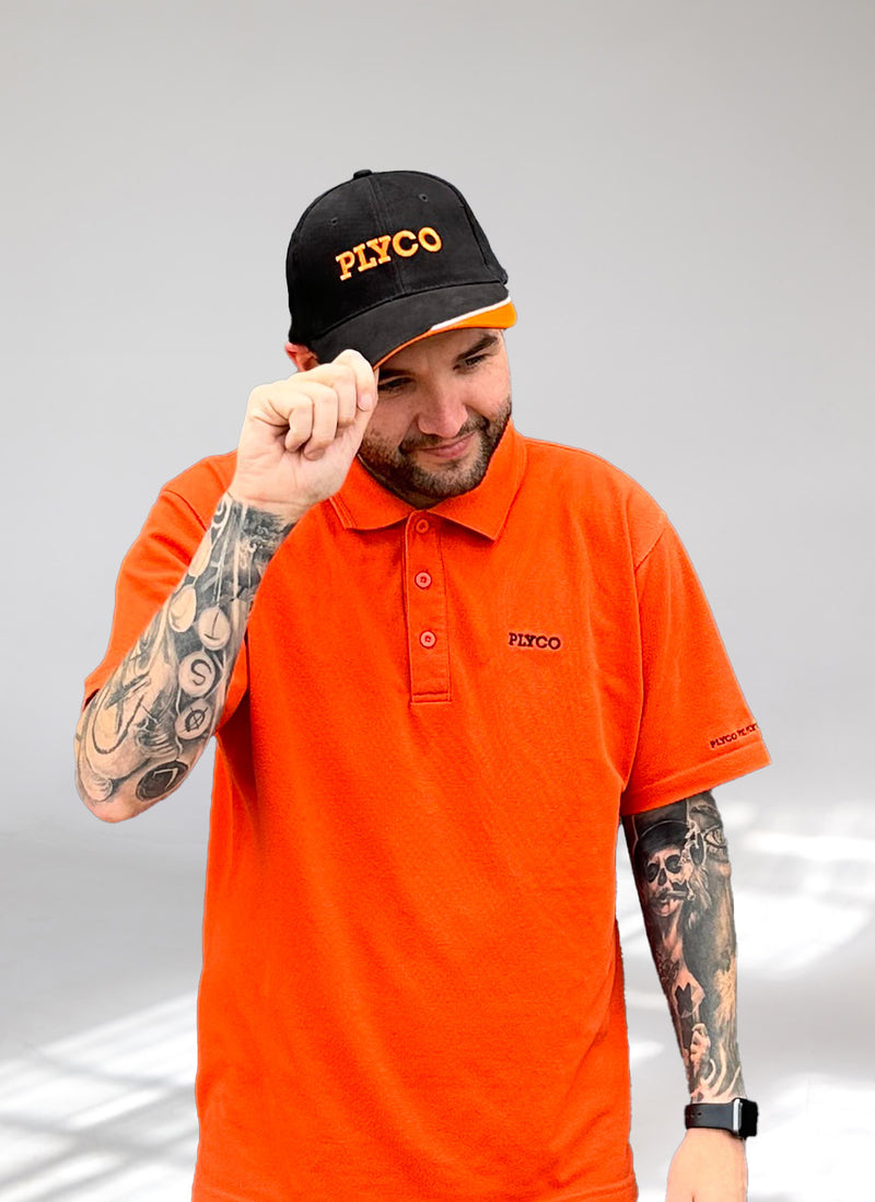Photo of Justin wearing Plyco's vintage black white and orange hat on a white background