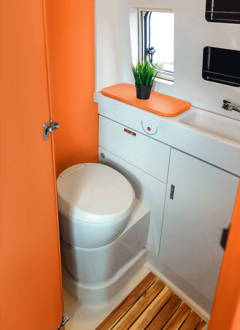 Bathroom in a RV / Caravan featuring 3mm Orange Vanply for interior caravan wall panels and cabinets from Melbourne plywood supplier Plyco without a white background
